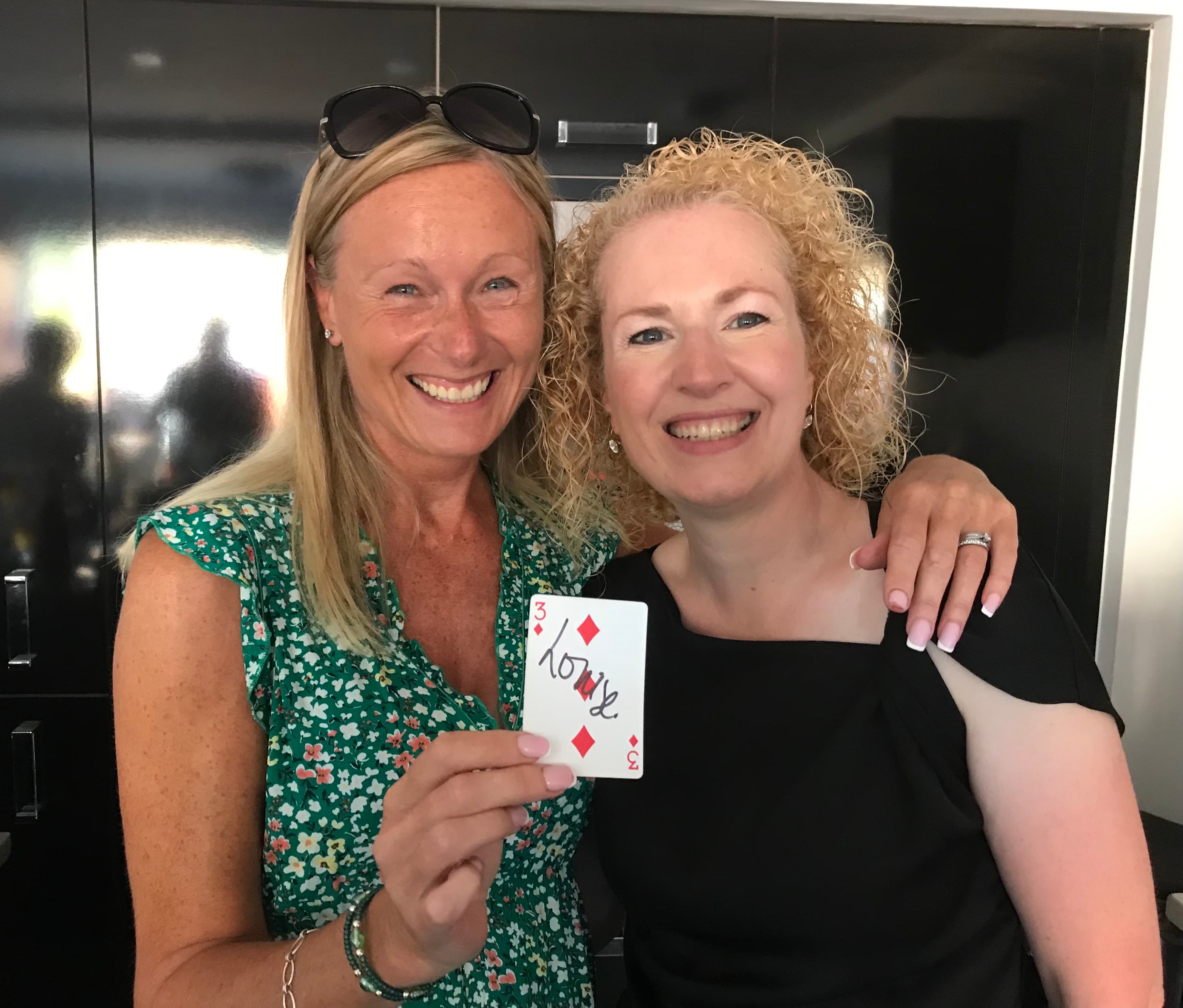 Two friends laughing after a magic trick